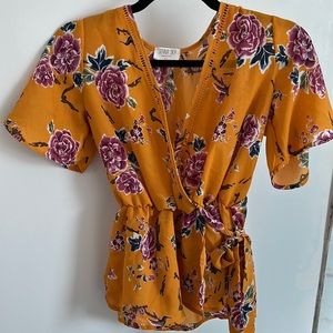 Sienna Sky XS mustard yellow floral faux wrap blouse